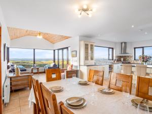 a kitchen and dining room with a table and chairs at Makeelan House in Renvyle