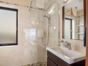 a bathroom with a sink and a shower at Makeelan House in Renvyle +35 photos