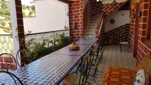 a patio with a table and chairs and a window at Kasabah Senhaji in Moulay Idriss +121 photos