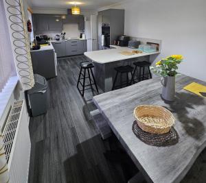 a kitchen and dining room with a table and a counter at Inverloch self catering in Orkney