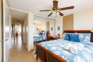 a bedroom with a bed and a ceiling fan at Island Escape in Fajardo +23 photos