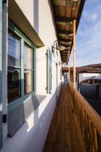 a balcony with a wooden floor and windows at Villa Sofija in Kojsko