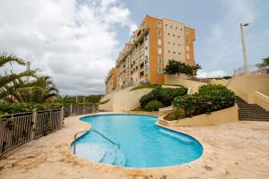 a swimming pool in front of a building at Island Escape in Fajardo