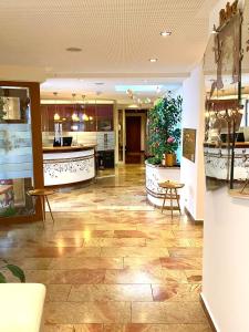 a lobby of a hotel with a counter and tables at HOTEL ZILLNERs EINKEHR *** in Altheim +38 photos