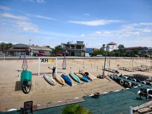 a group of surfboards lined up on a beach at AHHA Floatel Kampot in Kampot