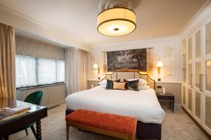 a hotel room with a bed and a desk at The Capital Hotel, Apartments & Townhouse - Small Luxury Hotels of The World in London +76 photos