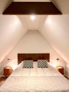 a bedroom with a bed with two pillows on it at Bommartini Guesthouse in Enschede