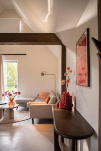 a living room with a couch and a table at Bommartini Guesthouse in Enschede