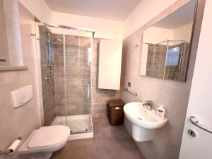 a bathroom with a shower toilet and a sink at Iseo Panorama Suite in Parzanica