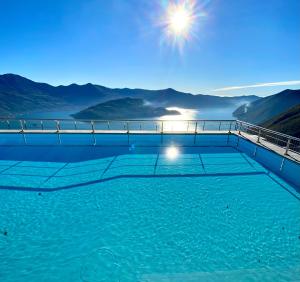 a swimming pool with a view of the mountains at Iseo Panorama Suite in Parzanica