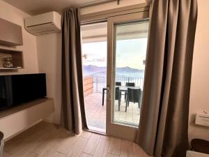 a room with a sliding glass door with a view of a balcony at Iseo Panorama Suite in Parzanica