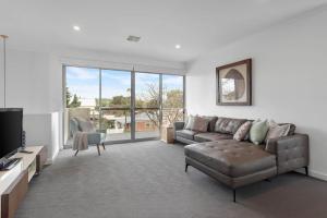 a living room with a couch and a tv at Atlantis - Coastal Retreat near Horseshoe Bay in Port Elliot