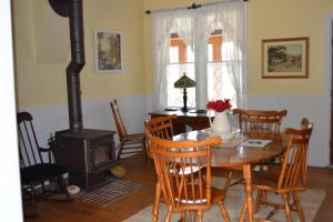 a dining room with a table and a wood stove at Somewhere In Time in Cedar