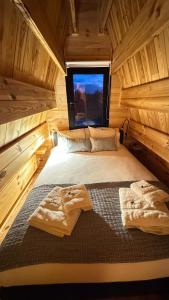 a bedroom with two beds in a wooden cabin at Chalé da Cumieira Nova in Seia +41 photos