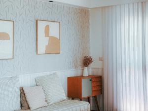 a bedroom with a bed and a table with a chair at Stylish Penthouse Beach Front in Ashkelon