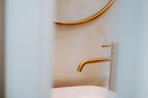 a bathroom with a toilet with a gold handle at Stylish Penthouse Beach Front in Ashkelon +32 photos