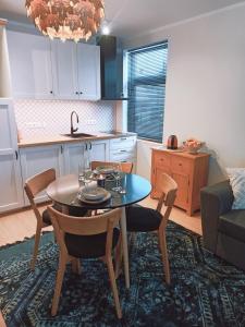 a kitchen and dining room with a table and chairs at Relax Inn Otepää Apartment in Otepää