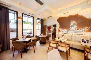 a restaurant with tables and chairs and a boat on the wall at Hotel MB in Metković