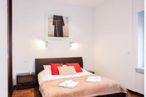 a bedroom with a bed with two towels on it at Centroom Apartment Zagreb in Zagreb