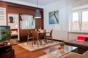 a living room with a table and a dining room at Centroom Apartment Zagreb in Zagreb