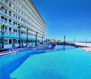a large swimming pool in front of a hotel at Beach Front Resort with Ocean View in Daytona Beach