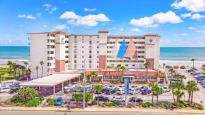 a hotel with a parking lot in front of the ocean at Beach Front Resort with Ocean View in Daytona Beach