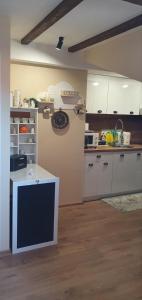 a kitchen with white cabinets and a counter top at Къща за гости ОЗИ 3 in Ovchartsi +16 photos