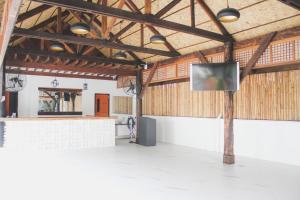 a large room with a flat screen tv on a pole at Treehouse Executive Villas - ANGELES in Malino