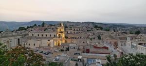 a view of a town with a church and a city at Pozzo Luce in Palazzolo Acreide