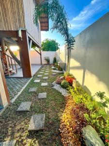 a garden with rocks and plants in front of a building at Treehouse Executive Villas - ANGELES in Malino