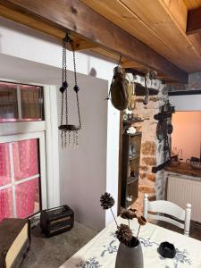 a dining room with a table and a stone wall at Lithos Home in Panagia
