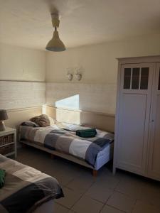 a bedroom with a bed and a window at Gîte de la chapelle in Houffalize