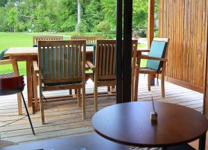 a patio with a table and chairs on a deck at Les Cabanes du Moulin de l'Ortille & SPA in Compiègne +49 photos