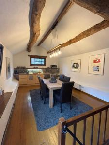 a kitchen and dining room with a table and chairs at Gîte de la chapelle in Houffalize
