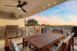 a wooden table on a deck with a view of the water at Twin Palms - Beachfront Duplex with Ocean Views & Direct Beach Access in Destin