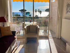 a living room with a view of the ocean at Cannes Events, Beach, Pool & Parking in Cannes