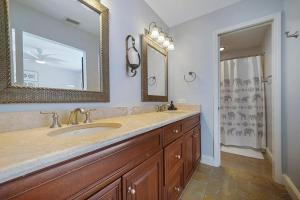 a bathroom with a sink and a mirror at Twin Palms - Beachfront Duplex with Ocean Views & Direct Beach Access in Destin +30 photos