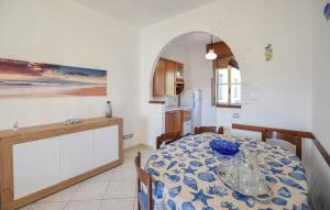 a kitchen and dining room with a table with a blue and white table cloth at Casa Vincenzo in Satriano +13 photos