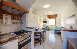 a kitchen and living room with a stove and a table at Casa Vincenzo in Satriano