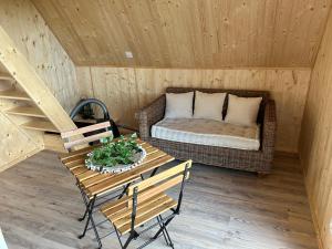 a room with a couch and a table in a cabin at Tiny house in Saint-Rémy-Boscrocourt