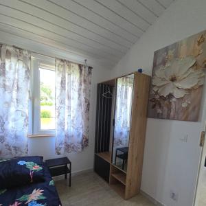 a room with a bed and a window with curtains at Agroturystyka Nad-Stawem 2 in Wielowieś