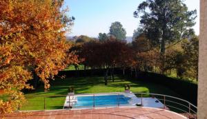 a house with a swimming pool in a park at Casa D Aitana in Pardaces de Arriba