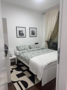 a bedroom with a bed and two pictures on the wall at Cozy apartment Kosmaj Residence in Rogača
