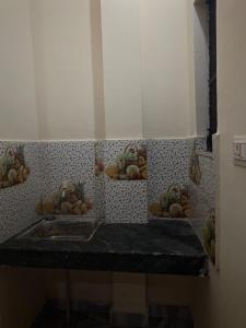 a counter with three bowls of fruit on a wall at Yamuna Bank Inn in Prayagraj