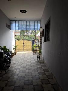an empty hallway with a door to a gate at Yamuna Bank Inn in Prayagraj