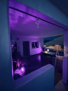 a purple room with a bed and a couch at Casa Dolly Boutique B&B in Cantoria