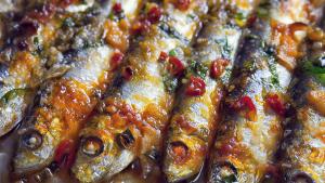 a close up of a group of fish with sauce at Sunrich Beach Resort in Ilandaiyadi
