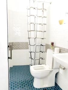 a bathroom with a white toilet and a sink at Ayona Beach Villa in Katuneriya +32 photos