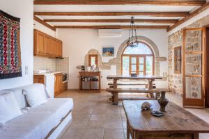 a living room with a couch and a table at Tzokeika Traditional Settlement in Riglia +51 photos