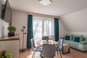 a living room with a table and a couch at Willa Bukowina in Bukowina Tatrzańska